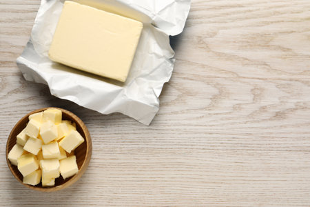 Tasty butter on light wooden table, flat lay. Space for textの写真素材