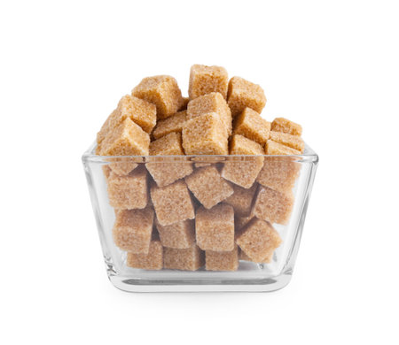 Brown sugar cubes in glass bowl isolated on whiteの写真素材
