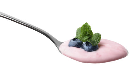 Spoon with yogurt, blueberries and mint isolated on whiteの写真素材