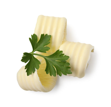 Tasty butter curls and fresh parsley isolated on white, top viewの写真素材