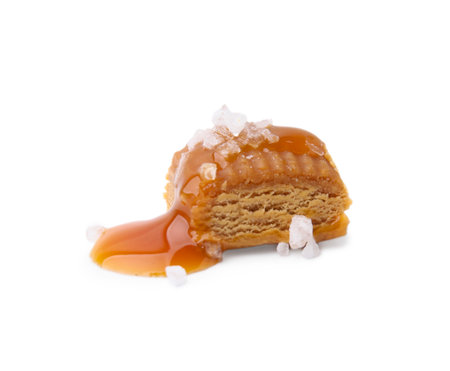 Yummy caramel candy and sea salt isolated on whiteの写真素材