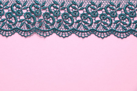 Green lace on pink background, top view. Space for textの写真素材