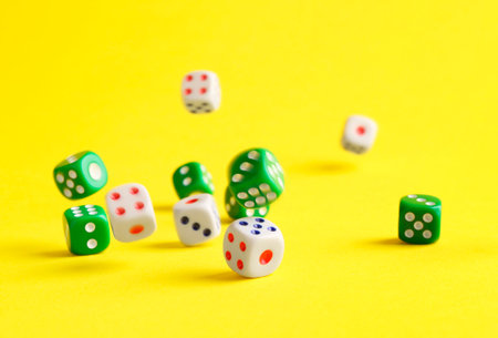 Many color game dices falling on yellow backgroundの写真素材