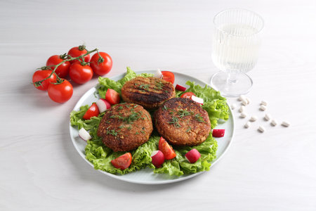 Delicious vegetarian cutlets served with vegetables on white tableの写真素材
