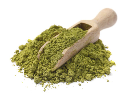 Henna powder and wooden scoop isolated on whiteの写真素材