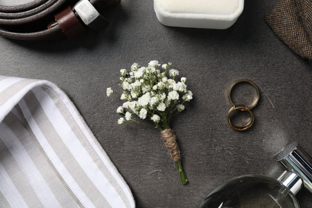 Wedding stuff. Flat lay composition with stylish boutonniere on black tableの写真素材