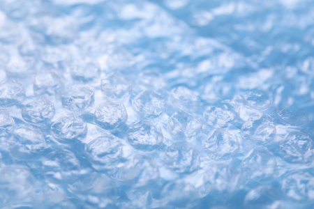 Transparent  wrap on light blue background, closeupの写真素材