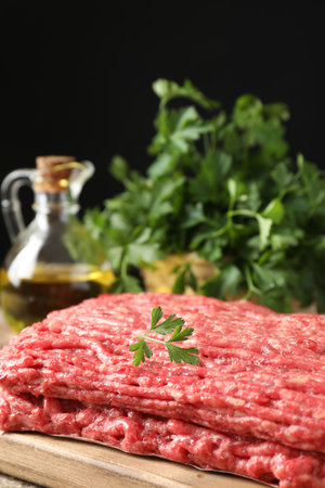 Raw ground meat and parsley on tableの写真素材