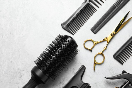 Hairdressing tools on light background, flat lay. Space for textの写真素材