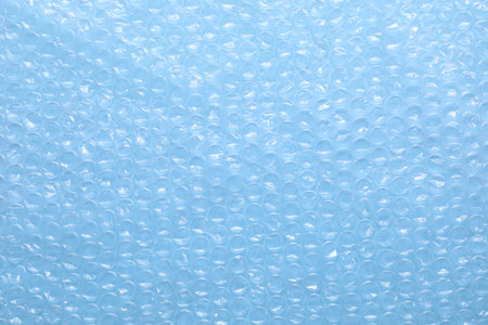 Transparent wrap on light blue background, top view