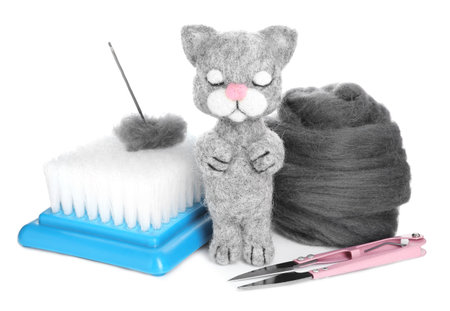 Needle felted cat, wool and tools isolated on whiteの写真素材