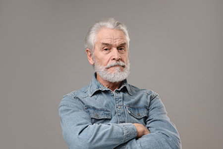 Senior man with mustache on grey backgroundの写真素材