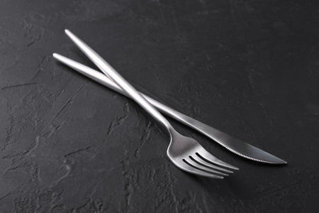 Set of beautiful cutlery on black table