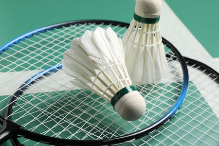 Feather badminton shuttlecocks and rackets on green table, closeupの写真素材