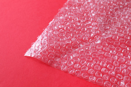 Transparent   wrap on red background, closeupの写真素材