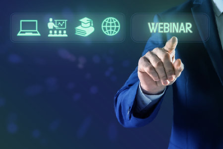 Webinar. Businessman using virtual screen with icons on blue background, closeupの写真素材