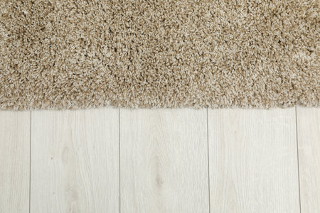 Soft beige carpet on white laminated floor indoors, top view. Space for textの写真素材