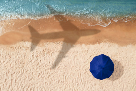 Shadow of airplane above sandy coast, aerial view. Summer vacationの写真素材