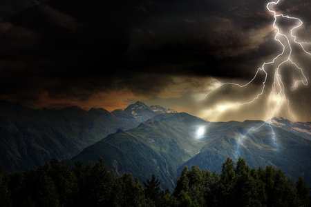 Thunder cloud with lightnings over mountains. Severe weatherの写真素材