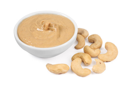 Delicious nut butter and cashews isolated on whiteの写真素材