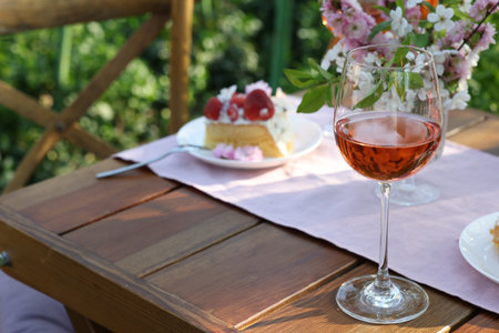 Glass of rose wine on table served for romantic date in gardenの写真素材