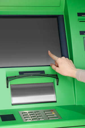 Woman using modern green cash machine, closeupの写真素材