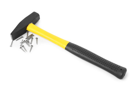 Hammer and metal nails isolated on whiteの写真素材
