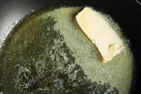 Melting butter in frying pan, top viewの写真素材