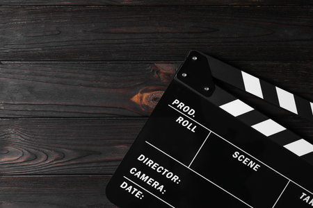 Clapperboard on wooden table, top view. Space for textの写真素材