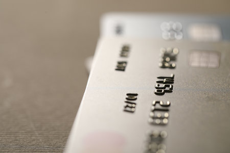 Credit card on beige background, closeup. Space for textの写真素材