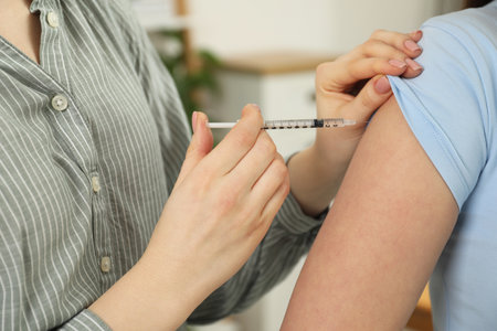 Diabetes. Woman getting insulin injection indoors, closeupの写真素材