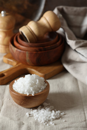 Organic salt in wooden bowl on tableの写真素材