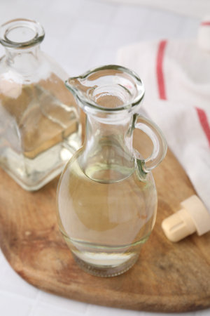 Vinegar in glass jug and bottle on tableの写真素材