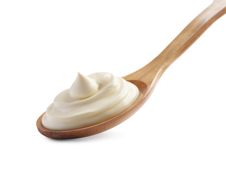 Natural yogurt in wooden spoon isolated on whiteの写真素材
