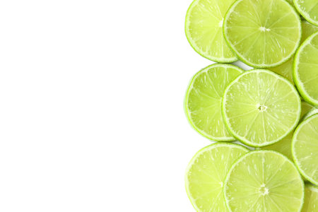 Fresh juicy lime slices on white background, flat lay. Space for textの写真素材
