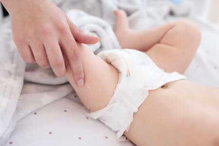 Mother with her cute little baby in crib, closeupの写真素材