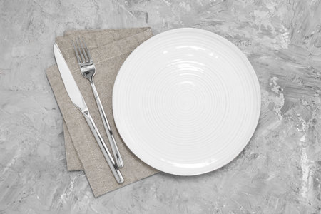 Elegant setting with shiny cutlery on gray table, top view