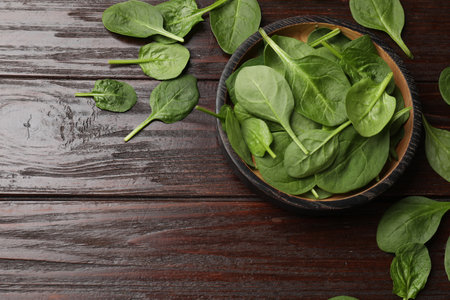 Fresh spinach leaves on wooden table, flat lay. Space for textの写真素材