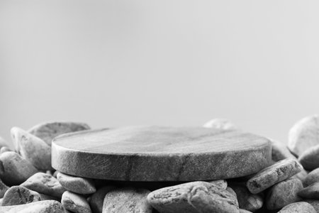 Presentation for product. Stone and pebbles on gray background. Space for textの写真素材