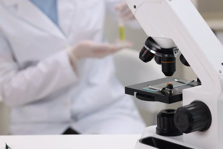 Quality control. Food inspector working in laboratory, focus on microscope
