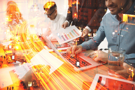 Double exposure of successful business team and night cityscape