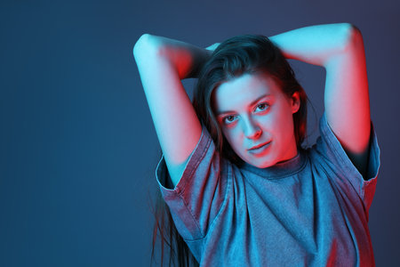 Portrait of beautiful young woman on color background