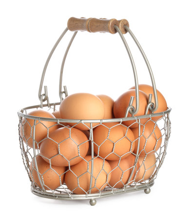 Chicken eggs in metal basket isolated on whiteの写真素材