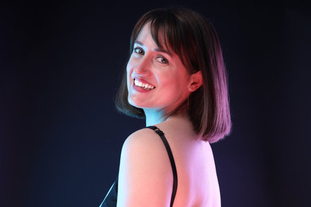 Portrait of happy woman on dark background