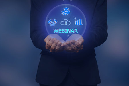 Webinar. Businessman holding virtual icons on color background, closeupの写真素材