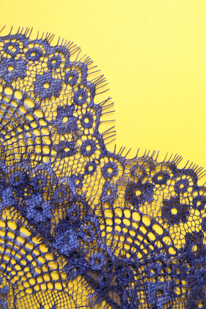 Blue lace on yellow background, top viewの写真素材