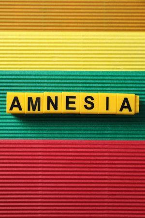 Yellow cubes with word Amnesia on color background, top viewの写真素材