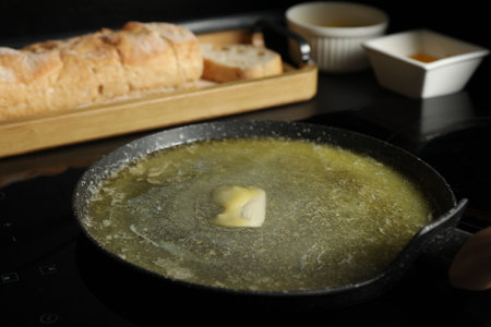 Melting butter in frying pan on cooktop, closeupの写真素材