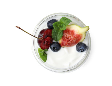 Glass with yogurt, berries and mint isolated on whiteの写真素材