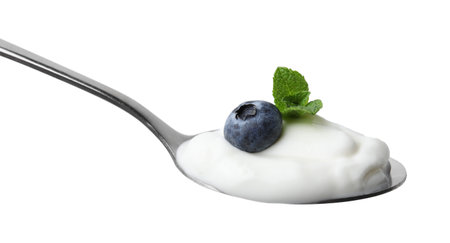 Spoon with yogurt, blueberry and mint isolated on whiteの写真素材
